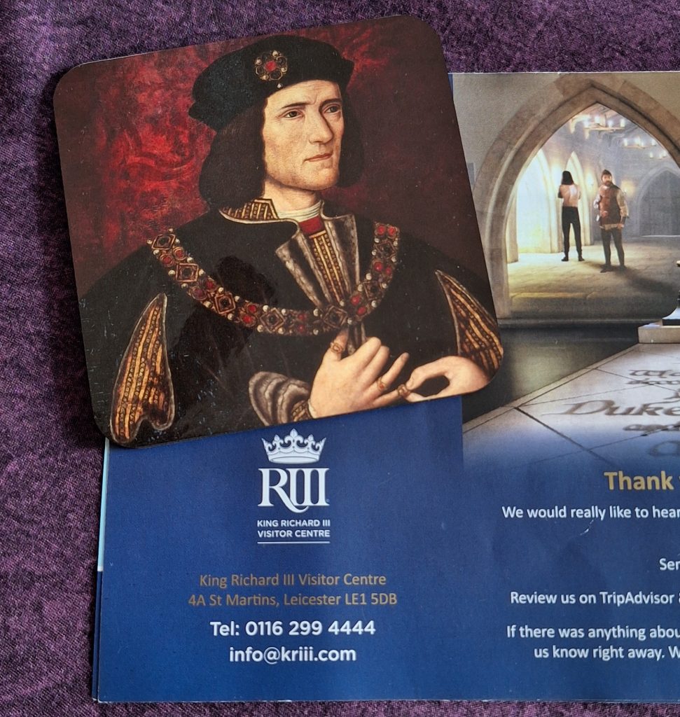 Portrait of Richard III resting on material from the King Richard III Visitor Centre